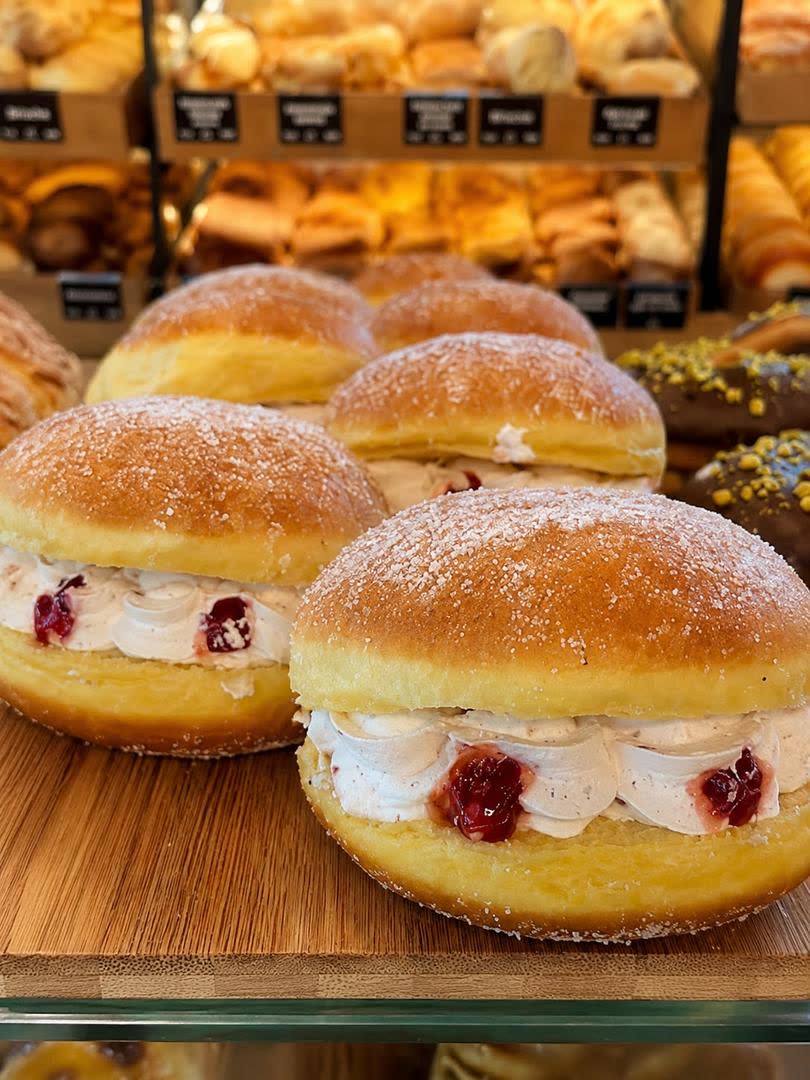 Bolas de Berlim polvilhadas com açúcar e recheadas de creme